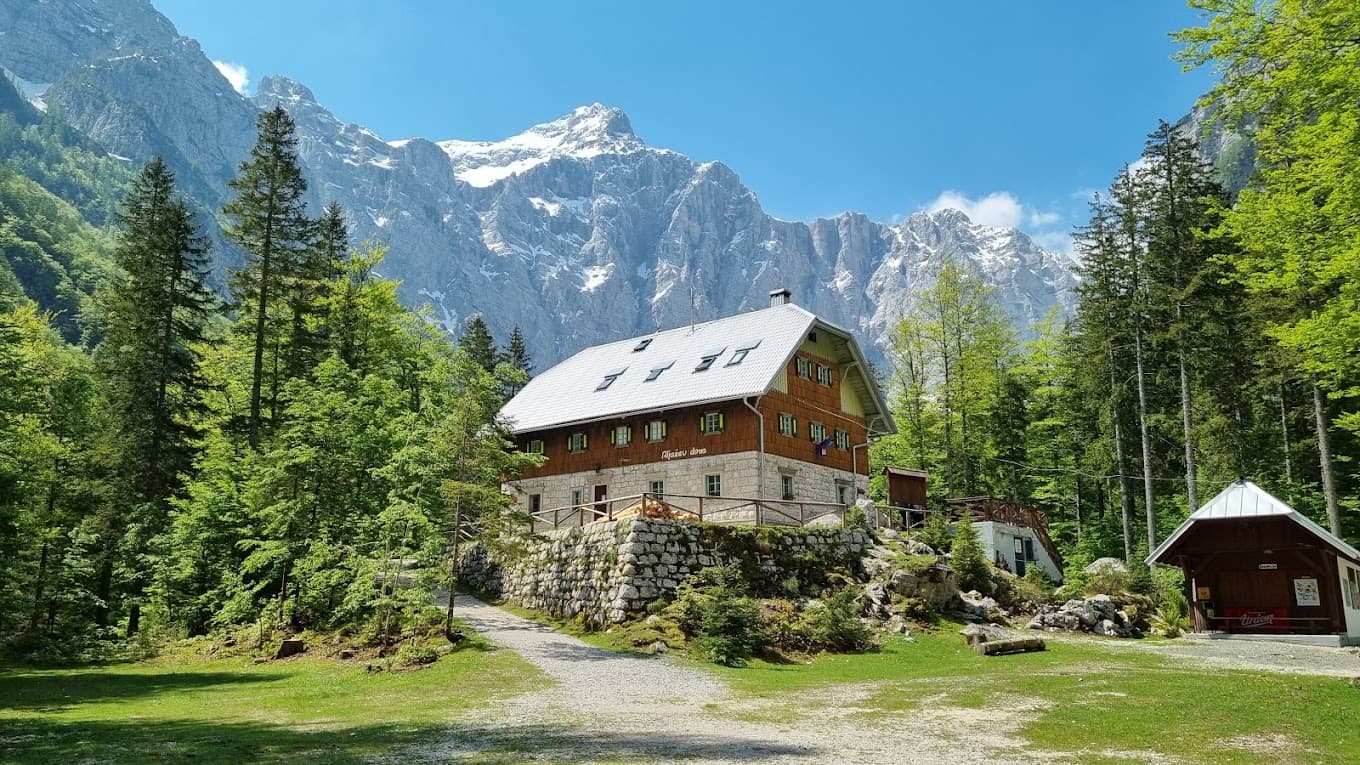 Aljažev dom mountain hut below snow-capped peaks in Vrata Valley, Slovenia