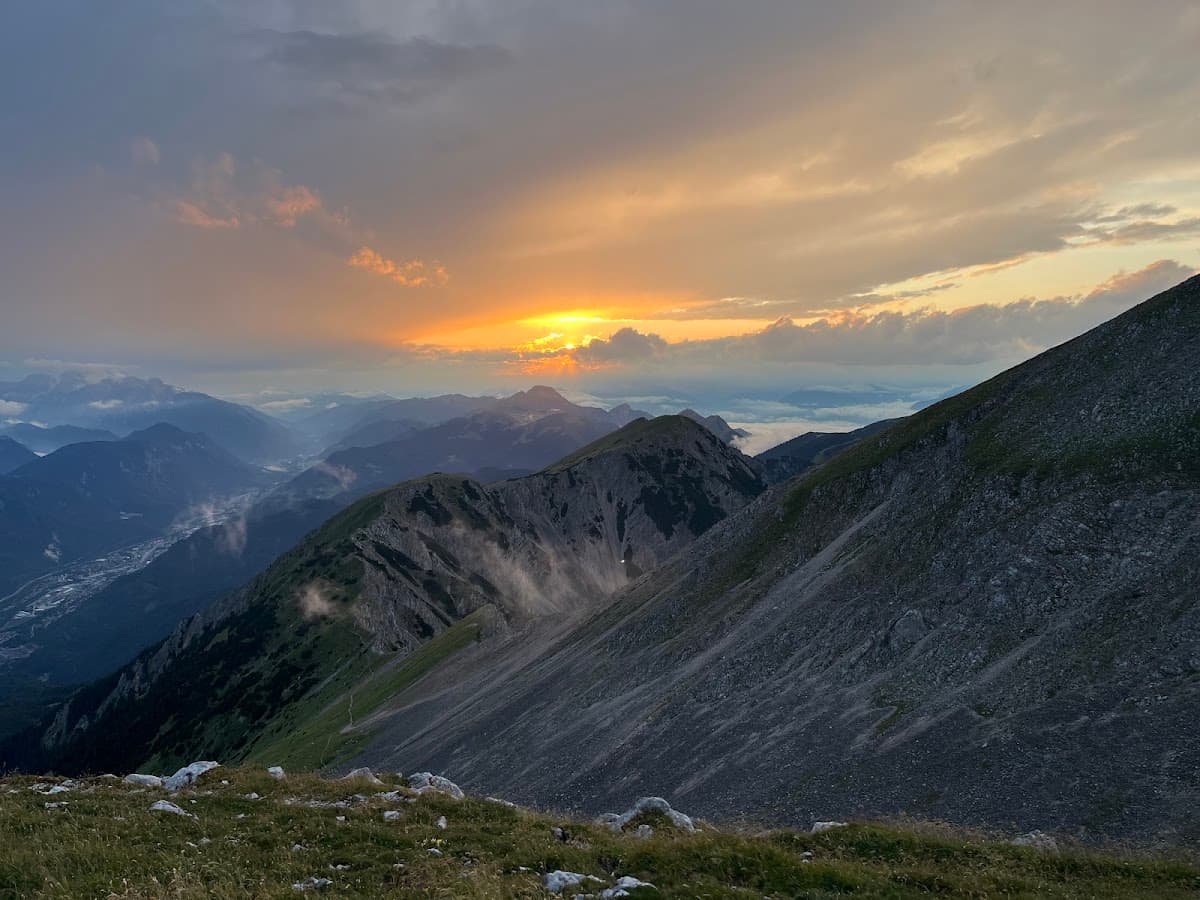 Mountain peaks at sunset with cloudy sky and valley view