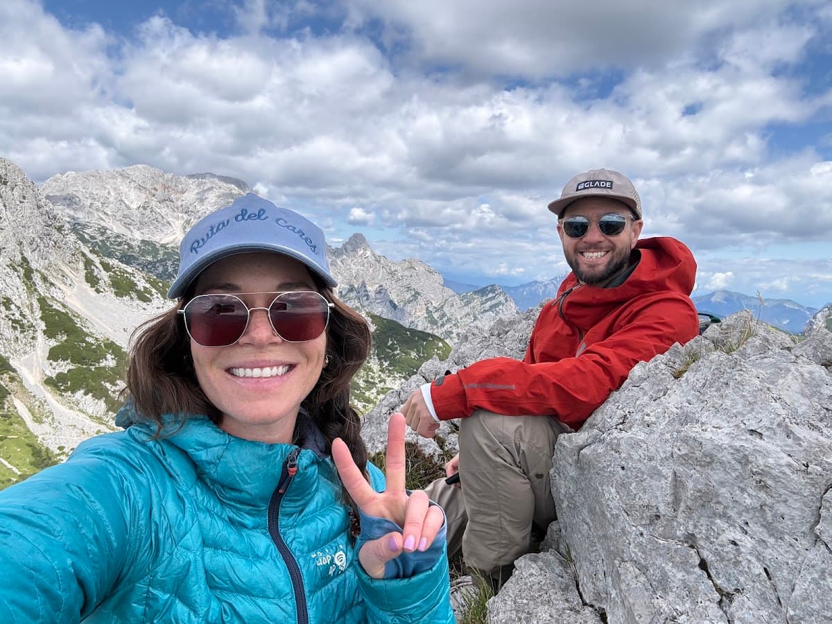 Hikers taking a selfie on rocky mountain summit with panoramic view