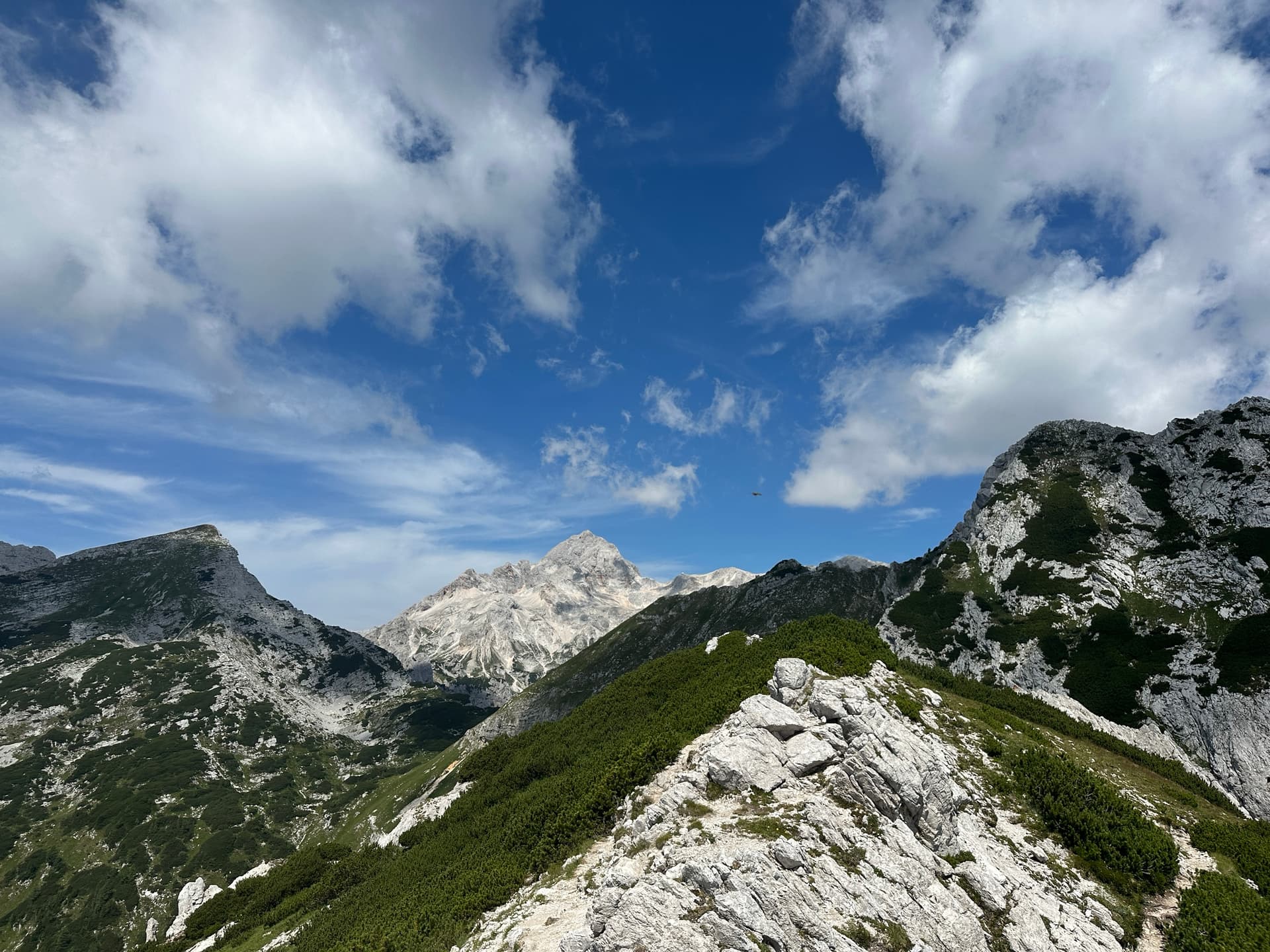 Alpine mountain ridge and rocky peaks under summer clouds